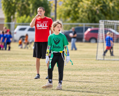Photo of a young female athlete playing Flag Football.